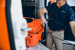 water damage restoration technician unloading equipment from vehicle