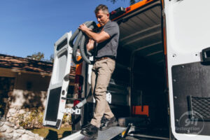 mold removal expert taking equipment out of van